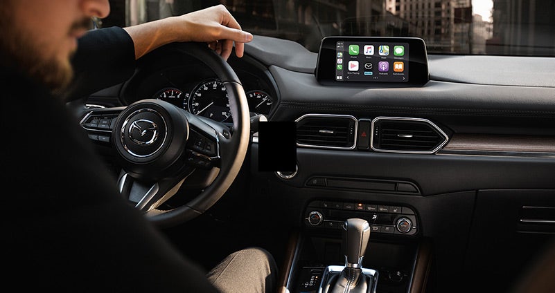 Man driving a 2020 Mazda CX-5 with black leather interior | Flood Mazda in Wakefield, RI