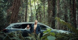 A father and son in a forest driving the 2020 Mazda CX-9
