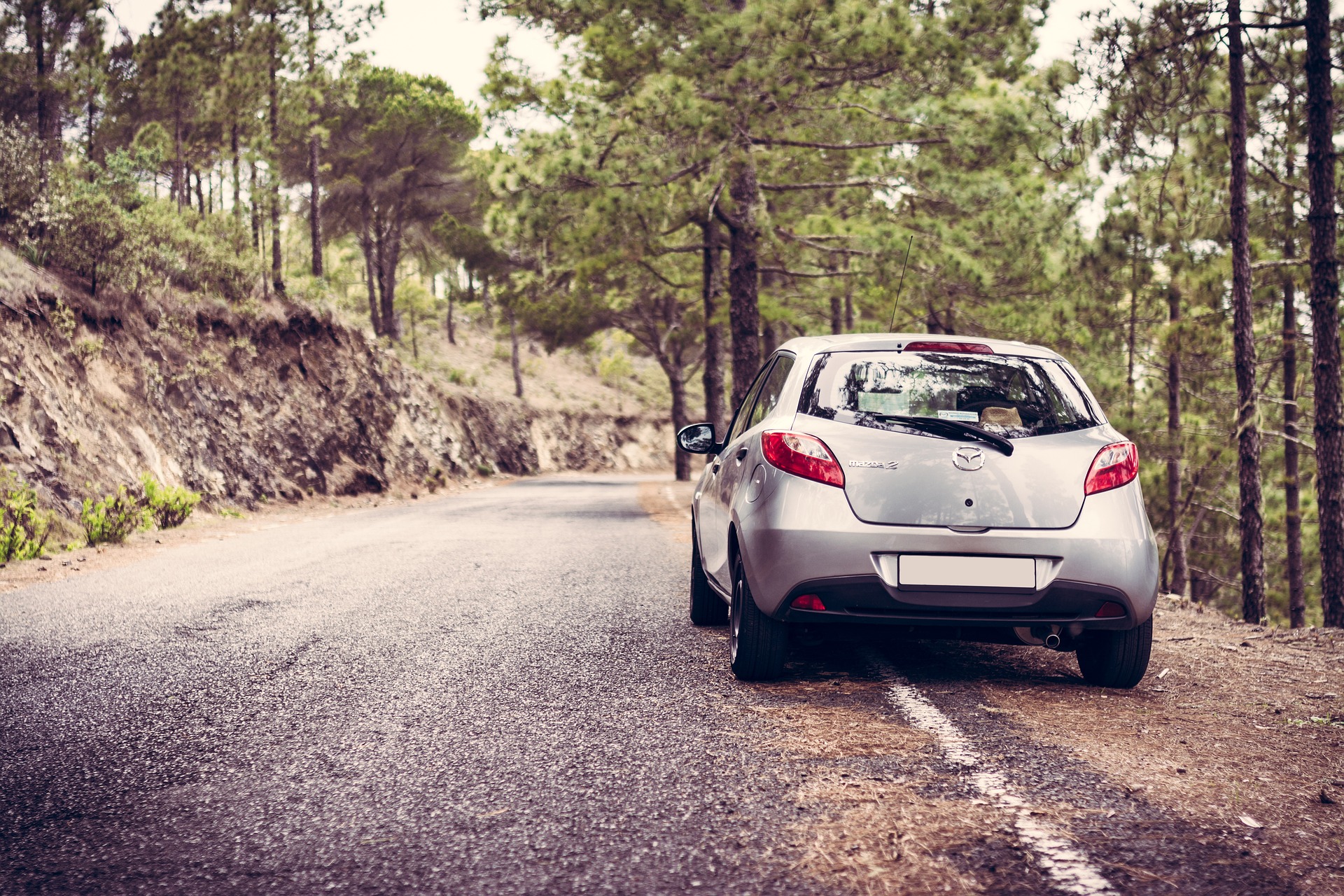 A silver Mazda parked on the road