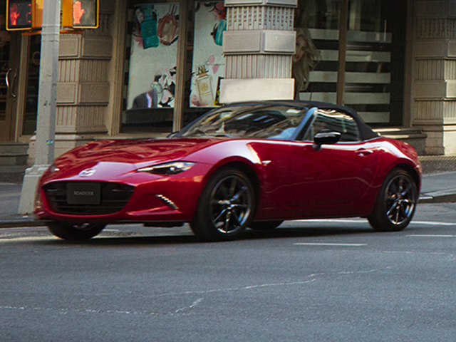 A red Mazda MX-5 Miata in the street