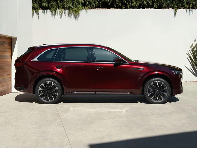 A dark red Mazda CX-90 parked outside